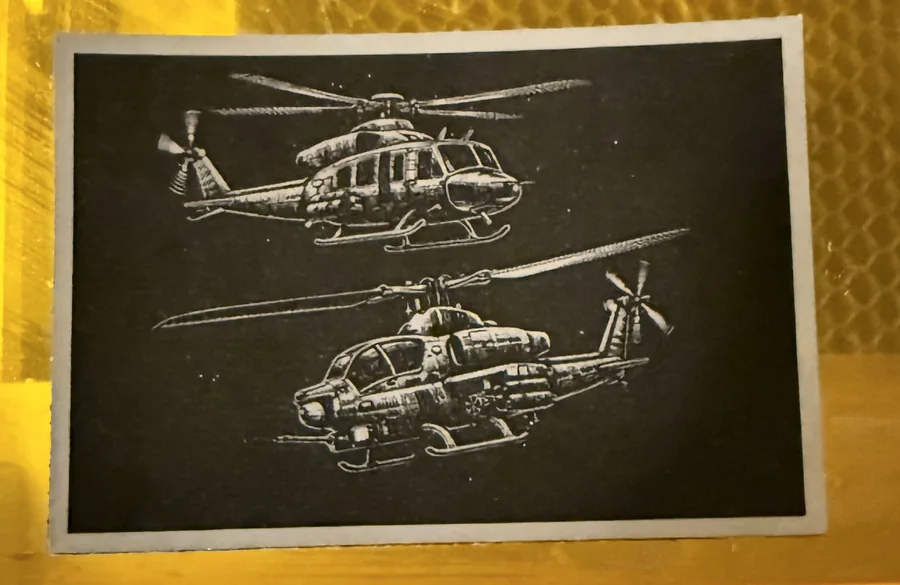 Helicopter artwork engraved into a dark leather patch